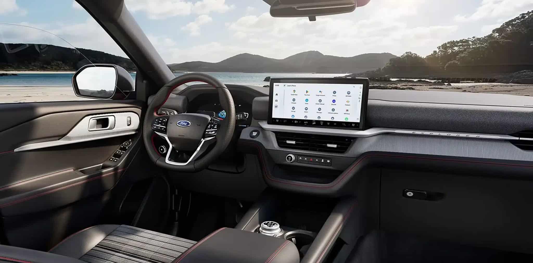 2027 Ford Explorer interior, dashboard and steering wheel by a coastal beach
